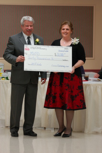 President Montgomery accepts a thirty thousand dollar check from Auxiliary President Montgomery at the 2008 Installation and Awards Banquet